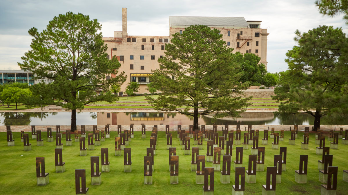 The Field of Empty Chairs fills the foreground, with the Reflecting Pool and Oklahoma City National Memorial Museum beyond.