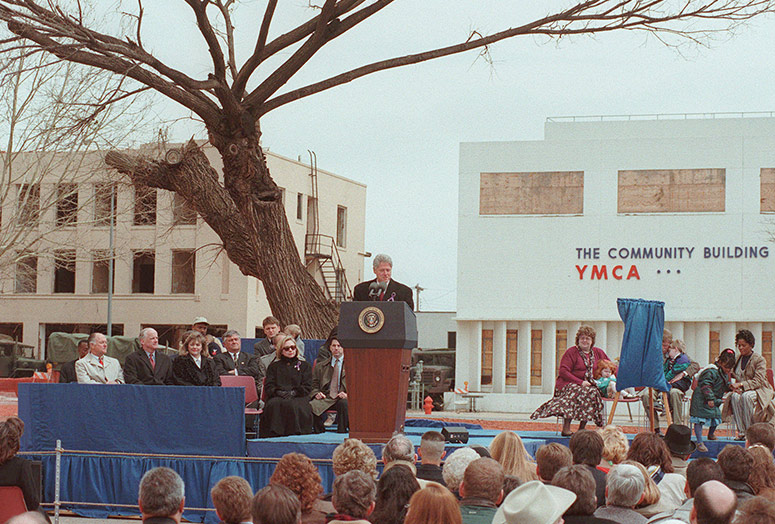 President Clinton speaking to leaders, the public and others in front of the damaged Survivor Tree in 1996.